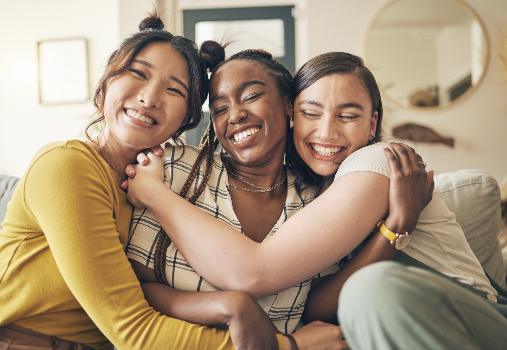 3 ladies hugging and smiling