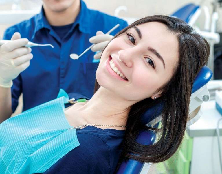woman in a blue shirt smiling